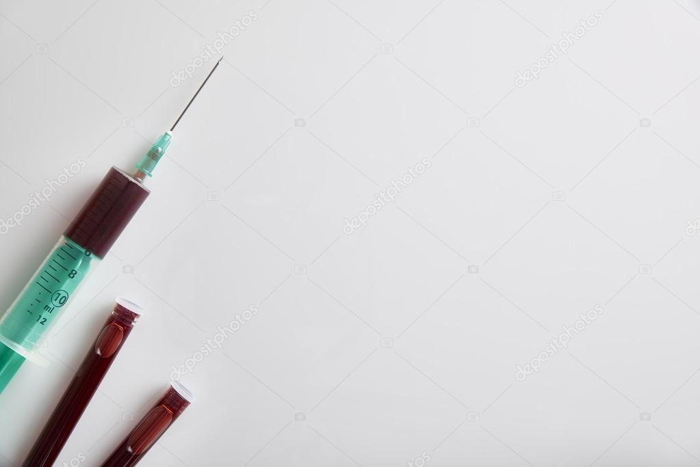 Syringe and vials with blood sampling top view