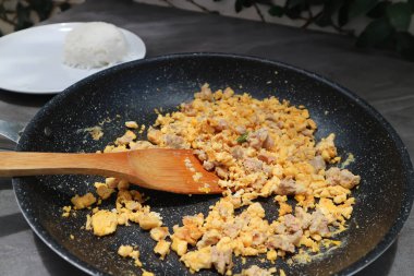 omelet or Thai omelet, Thai omelette or stir fried egg with pork in the pan