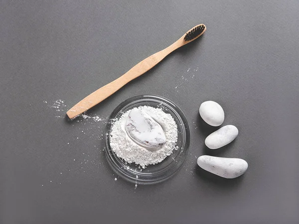 A bamboo toothbrush and toothpowder decorating with a stone. — Stock Photo, Image