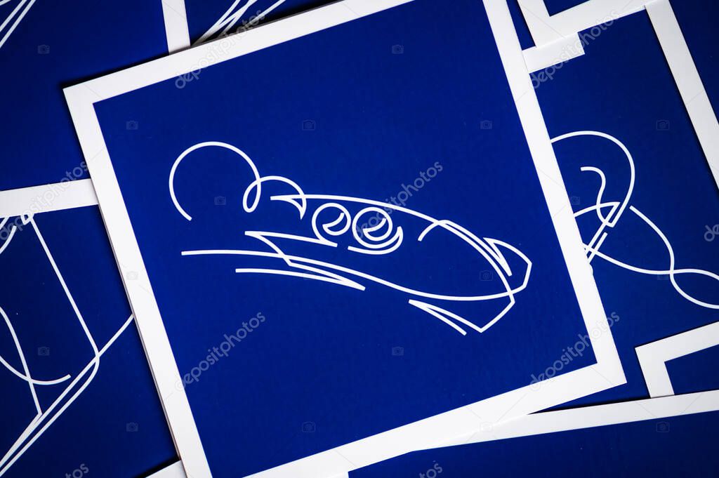 MILAN, ITALY, OCTOBER 20, 2025: Bobsleigh Blue pictogram for Winter Olympics Game 2026 in Milano and Cortina. Pictograms of other sports in Background