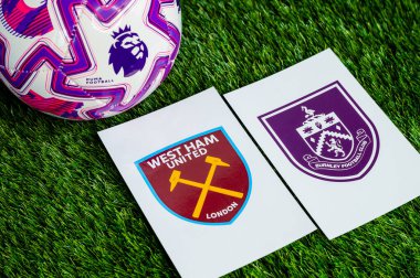 LONDON, UNITED KINGDOM, FEBRUARY 23, 2026: West Ham United - Burnley İngiliz Premier Ligi çatışması, kulüp armaları ve taze yeşil çimen arka planda futbol topu.