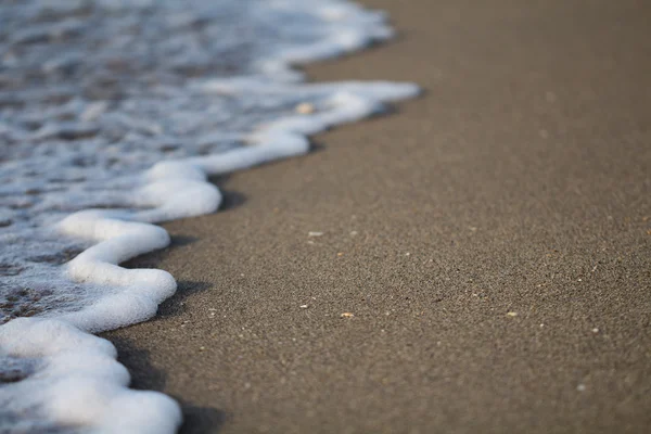 Withe poam in the beach — стоковое фото