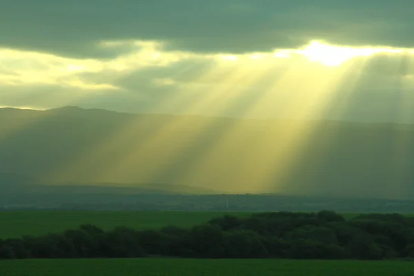 Sunlight through clouds — Stock Photo, Image