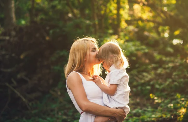 mother kisses daughter