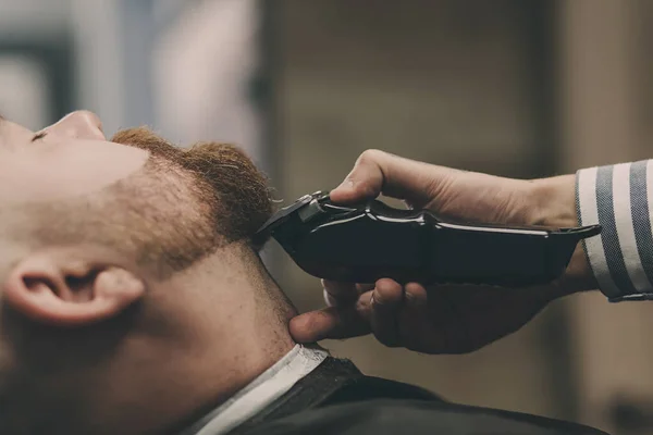 bearded man in barbershop hair care service concept