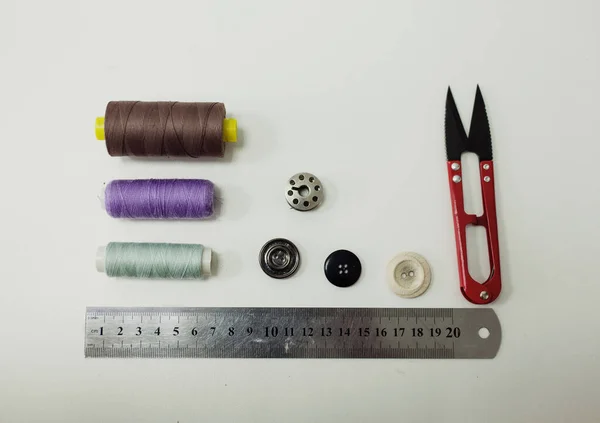 Accessories for tailoring on table. Thread, scissors, measure. Hobby