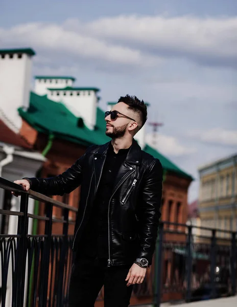 Young handsome man, leather jacket, sunglasses. Fashion style