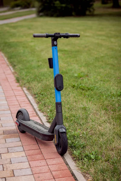 blue electric scooter on the road. ecological transport