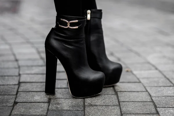 black leather boots with high heel.  Autumn street fashion look