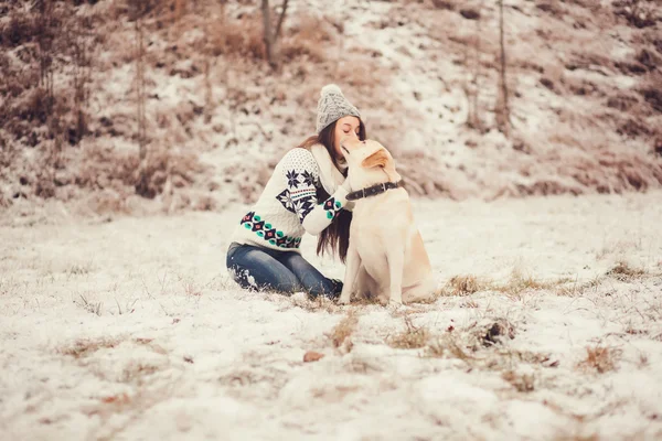 woman playing with dog