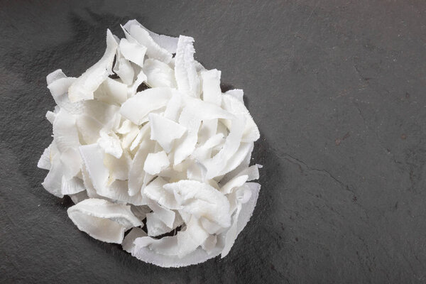 Coconut shavings on top of stone.