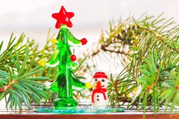 Small decorative glass snowman-toy and christmas tree — Stock Photo, Image