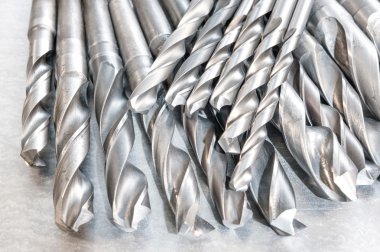 Metal drill bits. Drilling and milling industry. Closeup. clipart