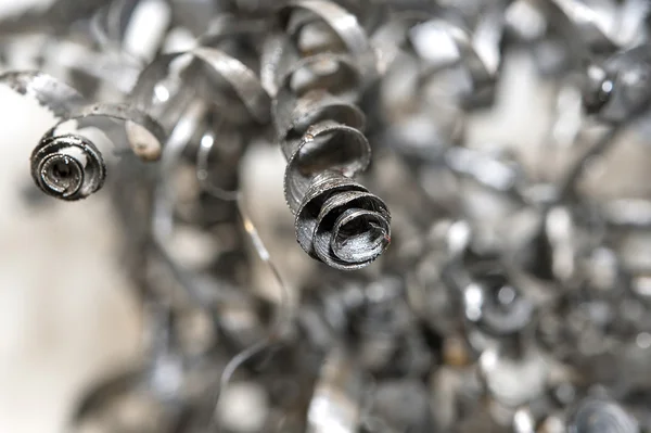 Closeup twisted spiral steel shavings. Drilling industry — Stock Photo, Image