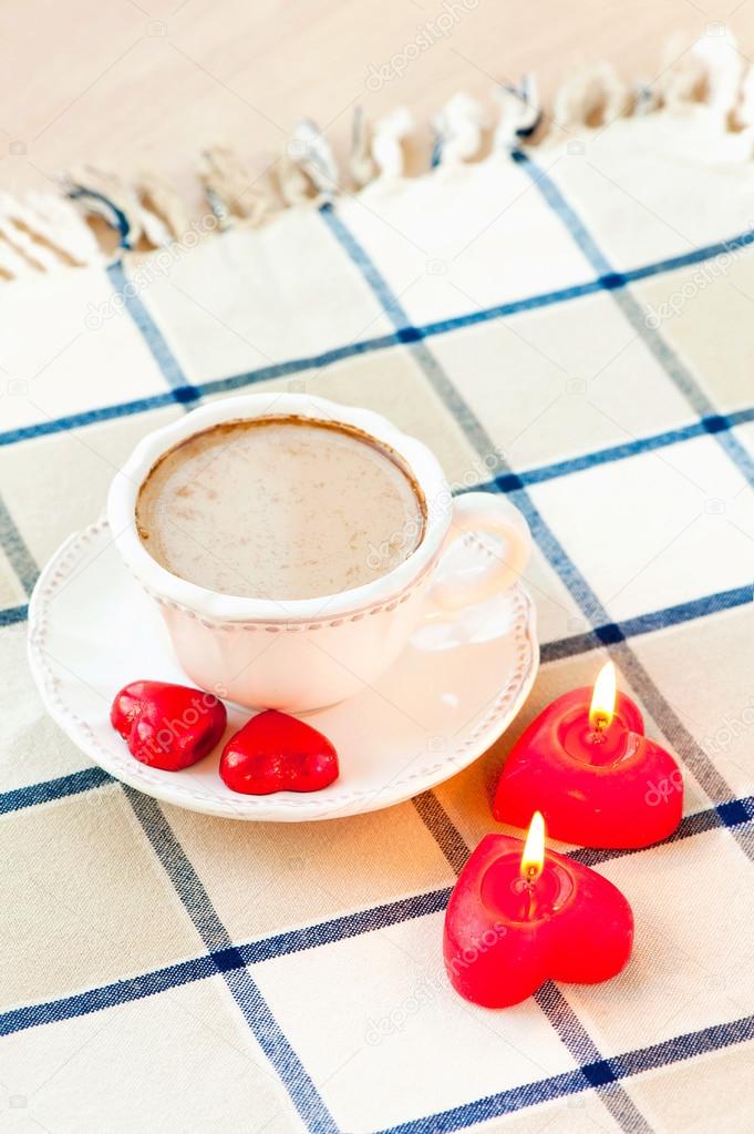 Valentine's day cup of coffee with heart shaped sweet chocolates