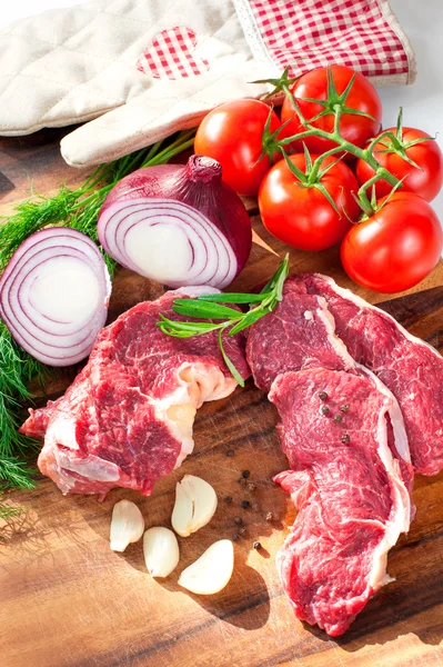 Fresh raw pieces of meet with vegetables ready to cook.