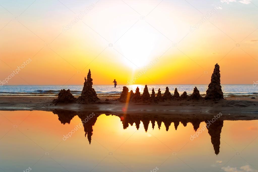 Beach with sandcastles on spectacular Baltic sea sunset backgrou