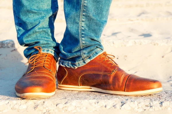 Mens legs in jeans and brown leather elegant  luxury shoes.