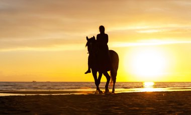 Horseriding güneş üzerinde Baltık Denizi kıyı şeridi boyunca silüeti