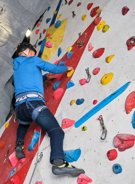 Professional senior man climbing on an artificial rock climbing wall. Extreme sports concept.