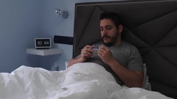 Young Latin Man Ill Bed Measuring Temperature Thermometer Taking Pill — Stock Video