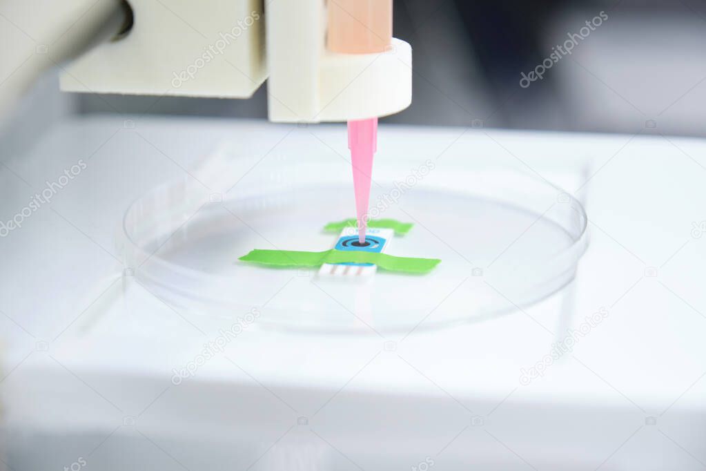 3D bioprinter ready to 3D print cells onto an electrode. Biomaterials, tissue engineering concepts.