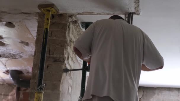 Constructor con martillo de demolición rompiendo una pared de la casa. — Vídeo de stock