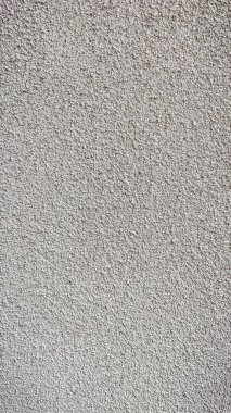 Gri alçı duvar yüzeyinin yüksek çözünürlüklü makro dokusu temiz bir mimari arkaplan sağlıyor