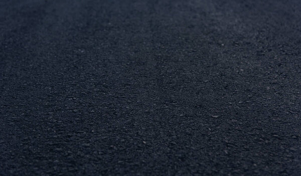 Texture details of surface of asphalt on new road with vignette.