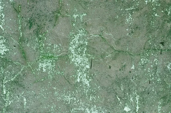 Yeşil boya kalıntılarıyla beton bir duvar. Arka plan.