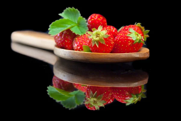 Strawberries fruit in big wood spoon with reflection — Stock Photo, Image