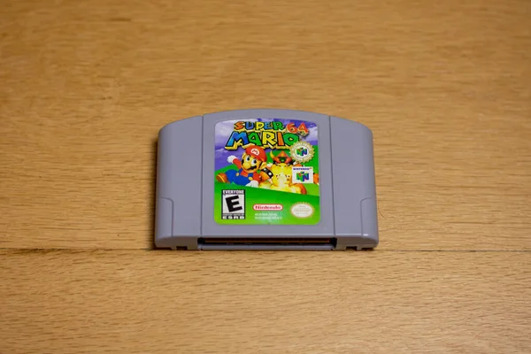 Tahta zeminde Nintendo 64 için bir Super Mario 64 fişeği..