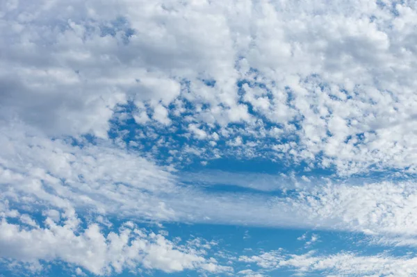 A Light Blue Sky With Whispy and Fluffy Clouds for Sky Replacement