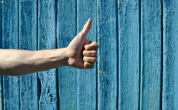 Man Hand Shows Close His Thumb Blue Wooden Background — Stock Photo, Image