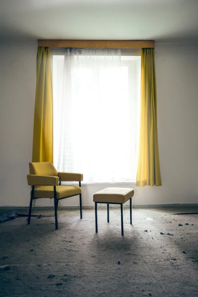 Chair and stool by the window — Stock Photo, Image