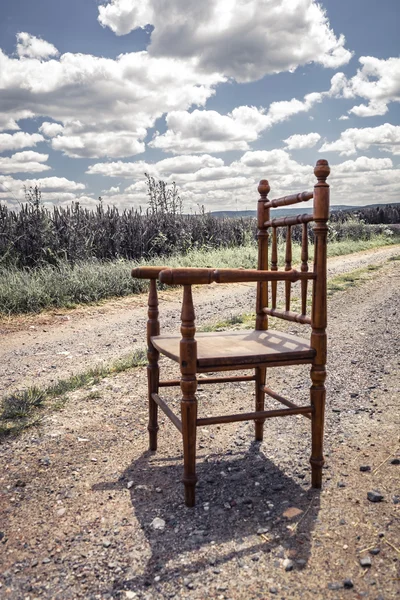 Chair on a dirt road — Stock fotografie