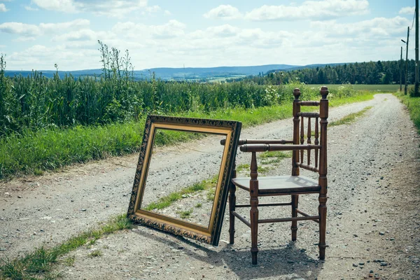 Chair with picture frame in nature — Stock Photo, Image