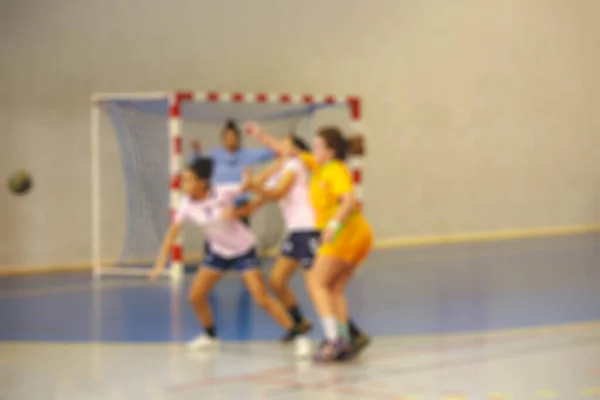 Blurred image of women handball players in action