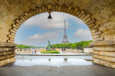 Paris, France - June 17, 2019: View of Eiffel Tower  through Pont de Bir-Hakeim bridge clipart