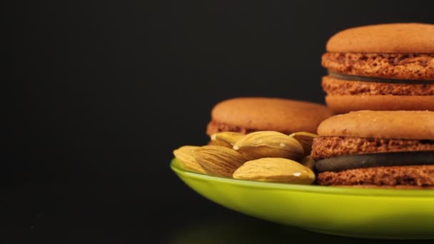 Brown Macaroons Almonds Saucer Rotate Black Background — Stock Video