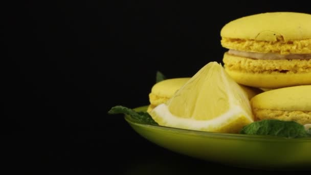 Yellow Macaroons Lemon Slices Saucer Rotate Black Background — Stock Video