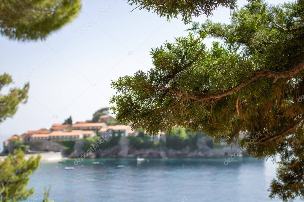 View on the Sveti Stefan island. Natural blurred background bokeh effect. Details of architecture in the old town. Hotel of millionaires in the Mediterranean.