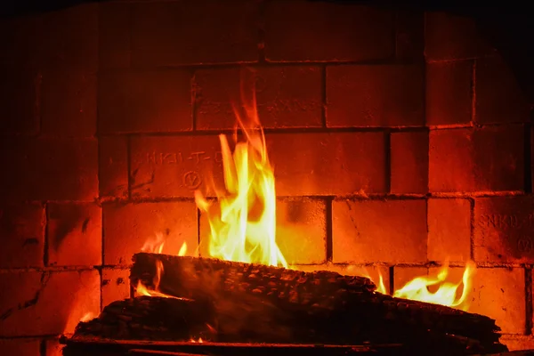 Vlammen en brand in de haard — Stockfoto