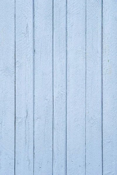 Wooden boards painted with light deep paint. The close-up conveys the texture of the slightly cracked paint over the wood grain well. The photo is perfect as a photo background