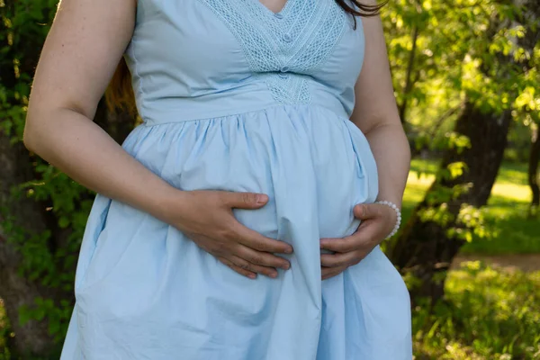 Pregnant Woman Blue Dress Hugs Her Stomach Her Hands Healthy — Stock Photo, Image