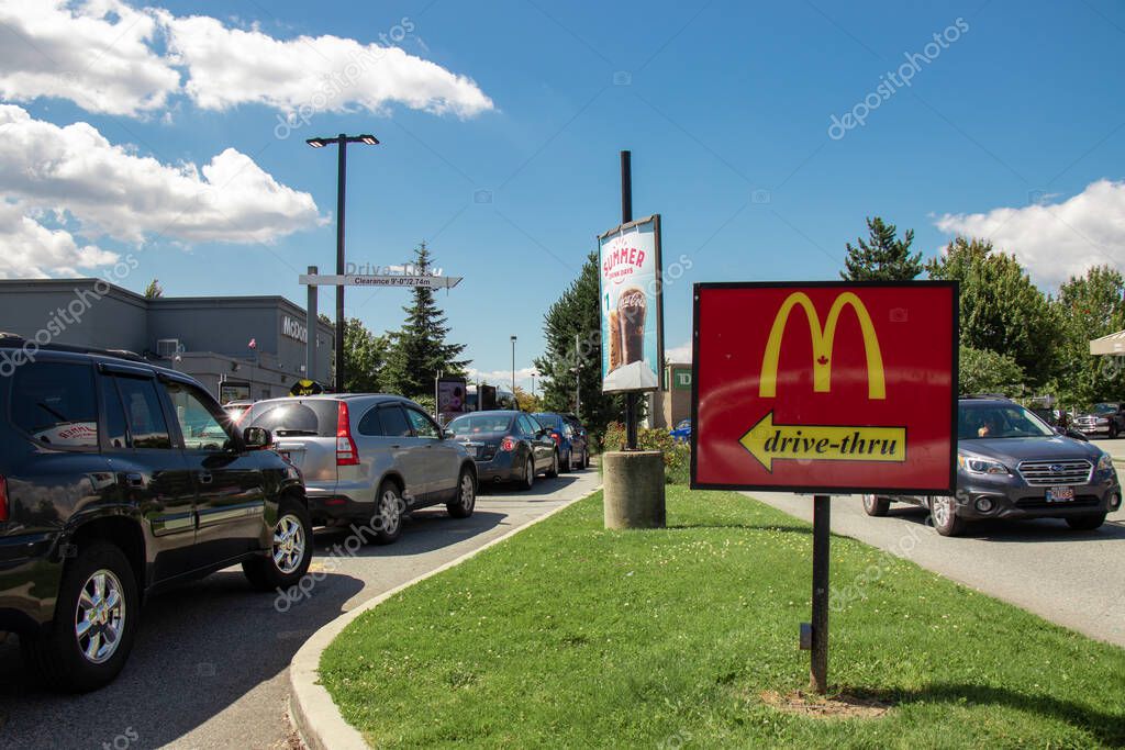 Vancouver,Canada - July 13,2020: Cars lining up to order food using drive-thru facilities at local McDonald's restaurant