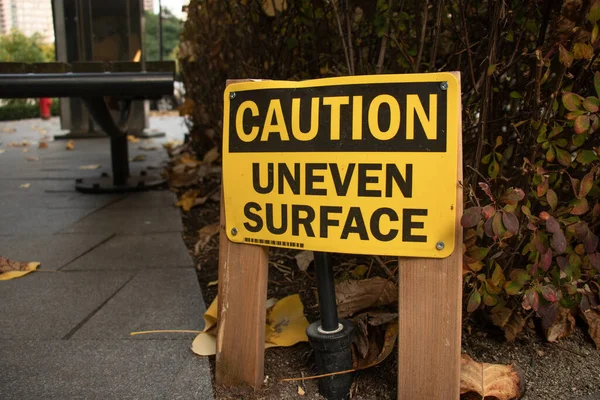 View Yellow Warning Sign Caution Uneven Surface Downtown Vancouver — Stock Photo, Image