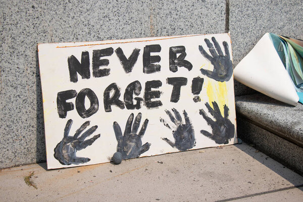 Vancouver, Canada - August 14,2021: Memorial for Indigenous children which remains have been found near the city of Kamloops in May. A view of sign Never Forget in front of Vancouver Art Gallery