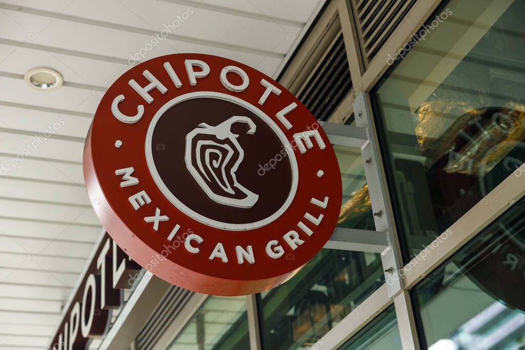 North Vancouver, Canada - Sep 25,2025: Vibrant red Chipotle Mexican Grill sign with iconic chili pepper logo
