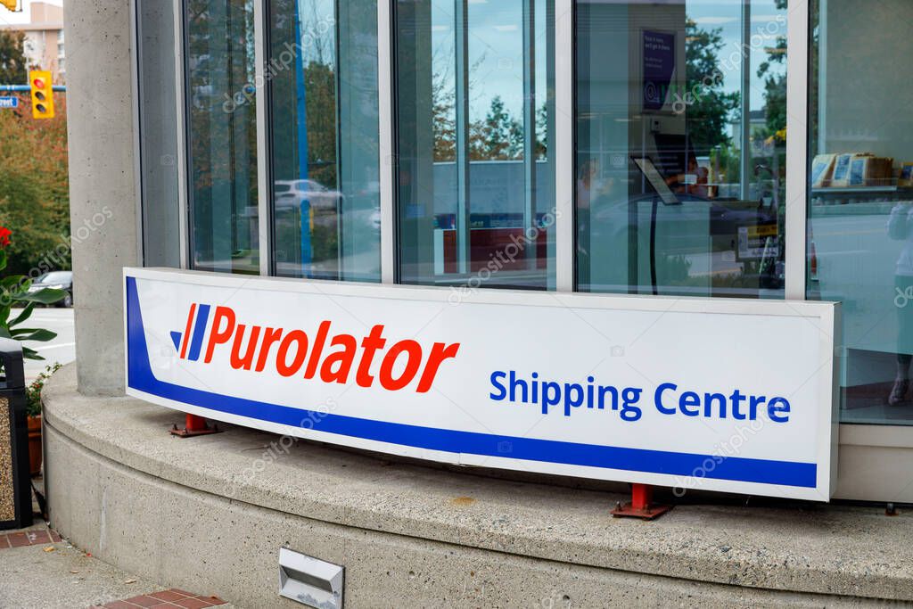 North Vancouver, Canada - Sep 25,2025: Vibrant Purolator shipping centre sign in bold red and blue on glass storefront facade